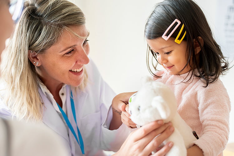paediatric specialists examining a little girl