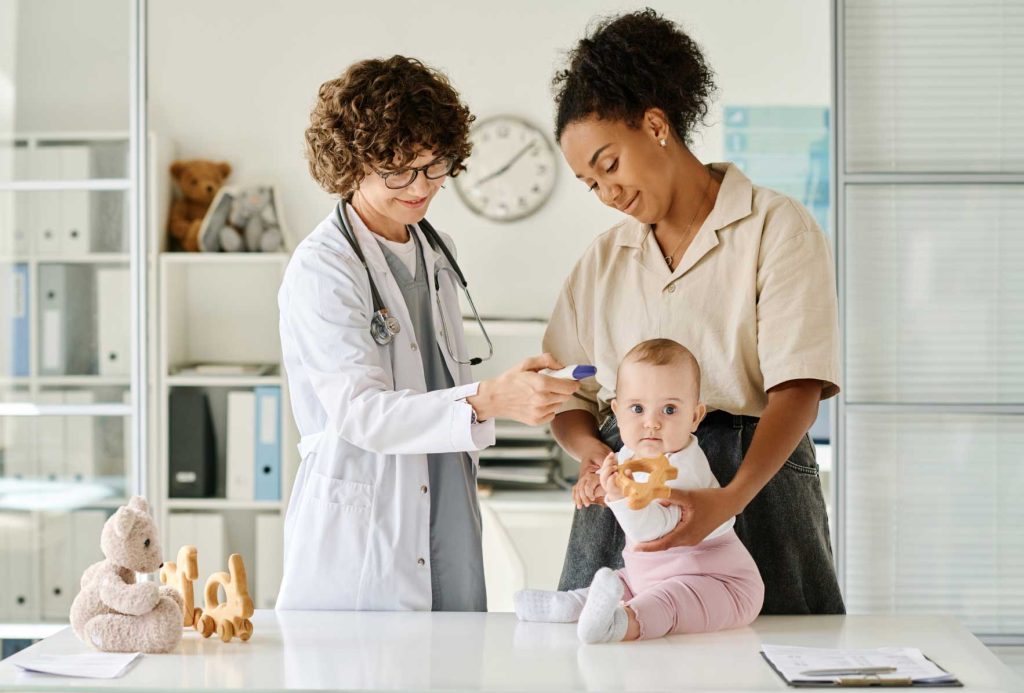 Doctor examining a baby, showcasing child health services